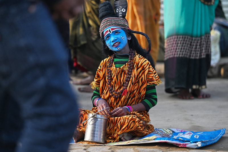 Childhood with Shiva God of Hindu on the eve of the annual celebration of Maha Shivaratri Festival in India; Photo Source: Theguardian; Photographer Name: Punit Paranjpe