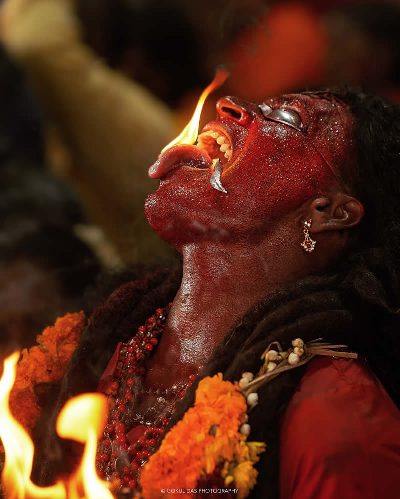 Indian man running ritual with fire