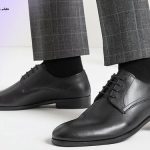 Black derby men's shoes with a suit, one of the types of shoe models, is suitable for men's suit.