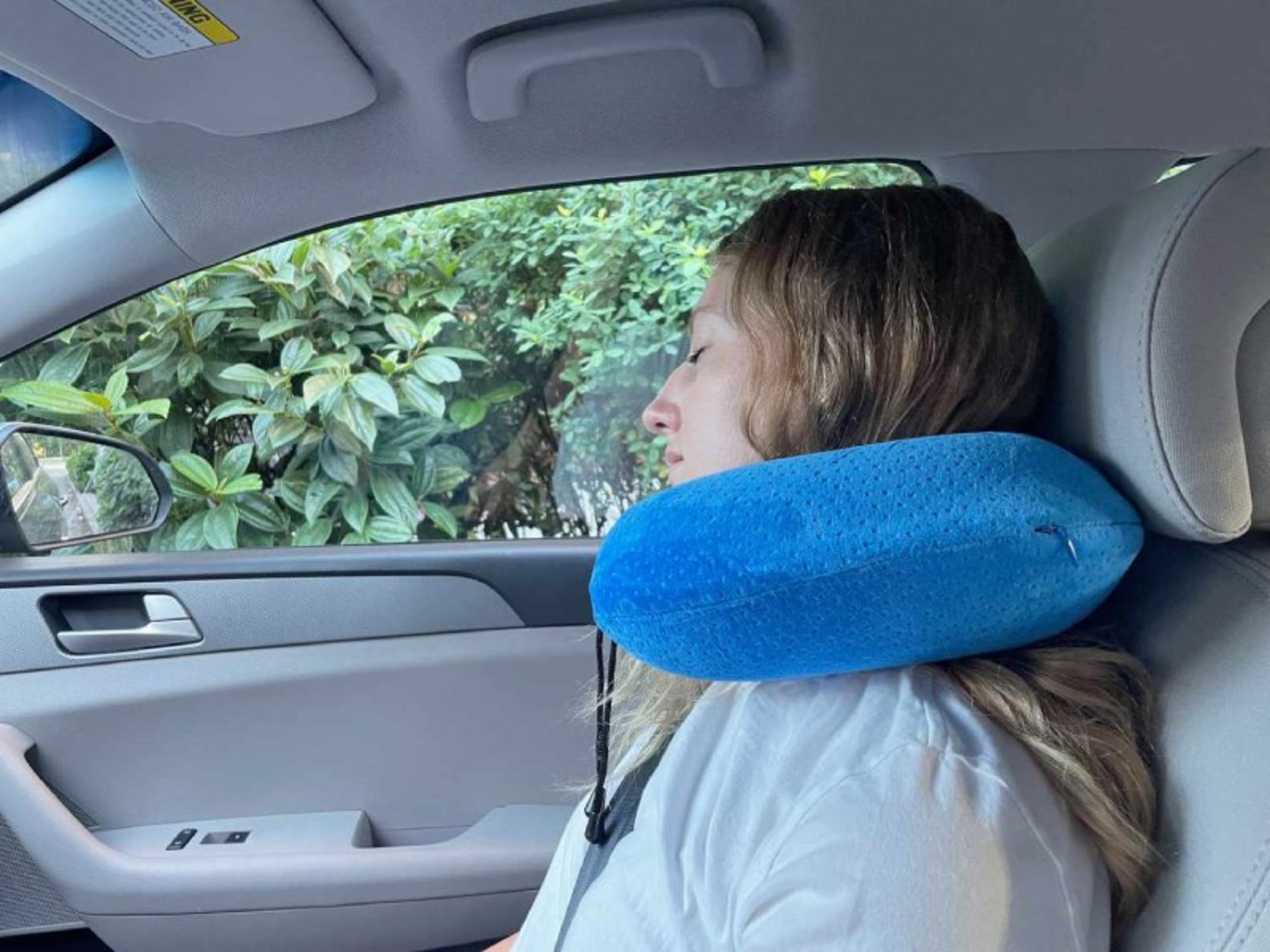 A neck pillow to travel with a personal car