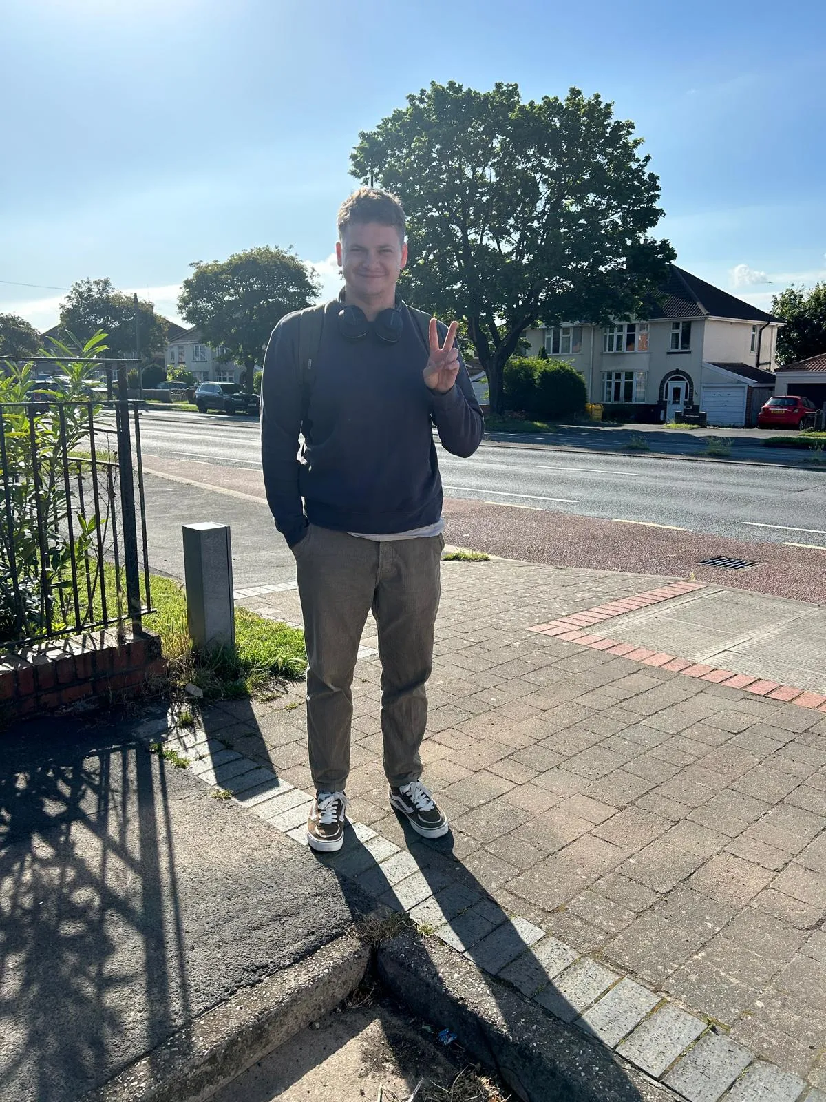 The man who stands in front of the camera and smiles is given to artificial intelligence.