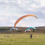 Landing paragliders on the grass ground in Kalardasht
