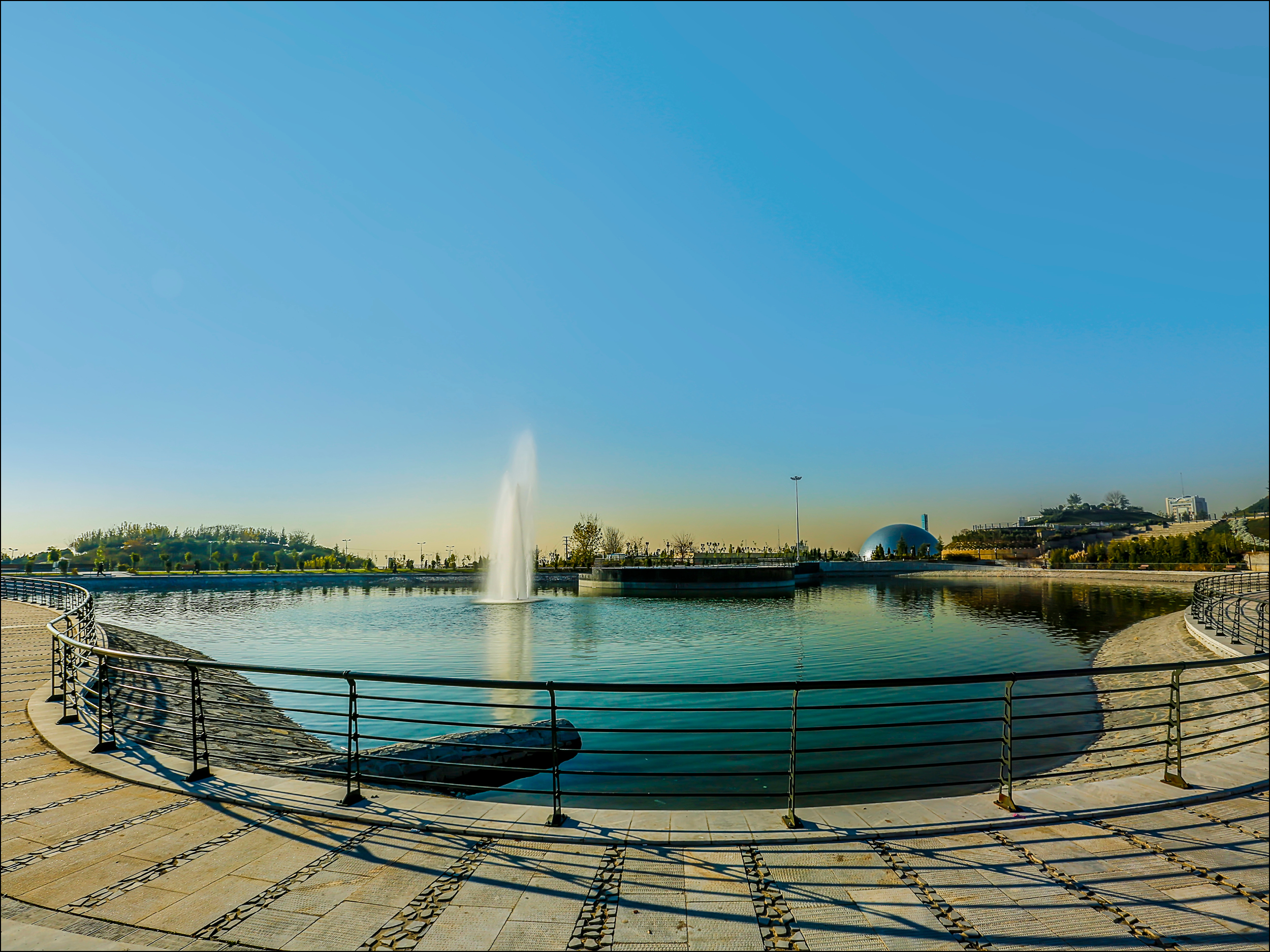 The metal fences around a small lake