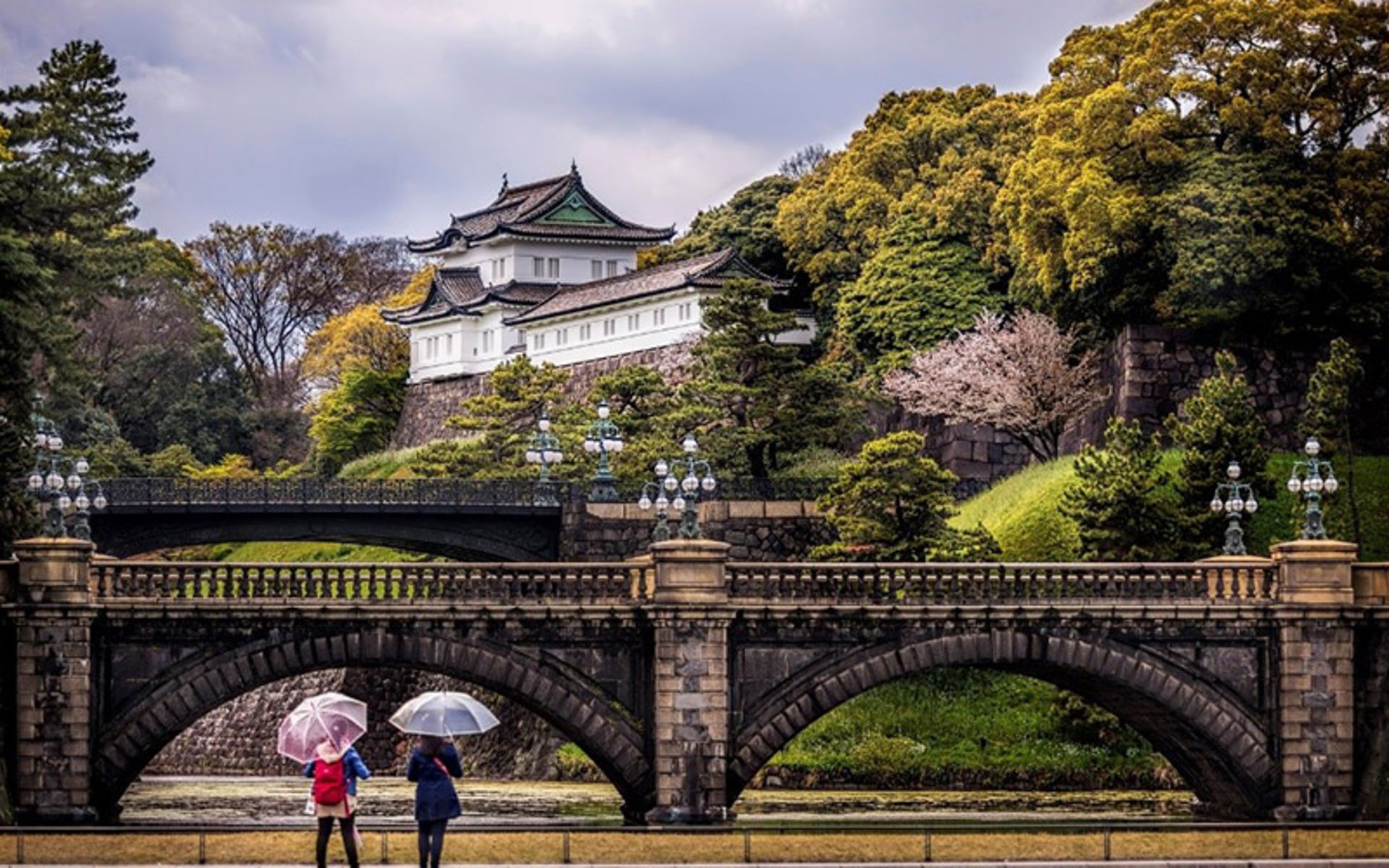 Tourists in the lush courtyard of the Tokyo Empire