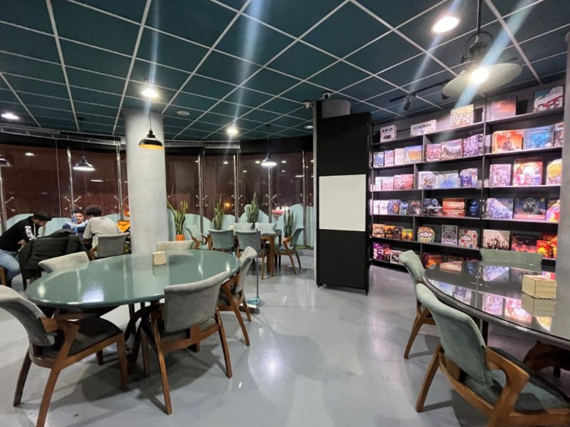 Qom Cafe Cafe Hall with different games shelves