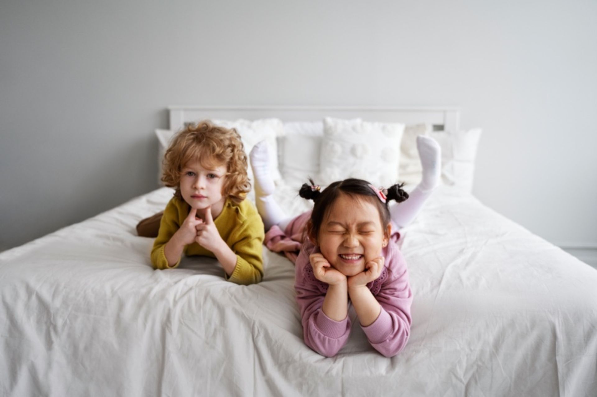 Two children on the hotel bed
