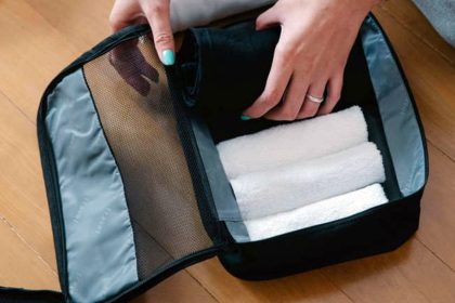 Towel and travel sheets in the suitcase
