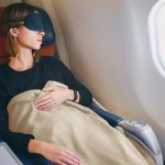 Using a blanket to sleep on the plane