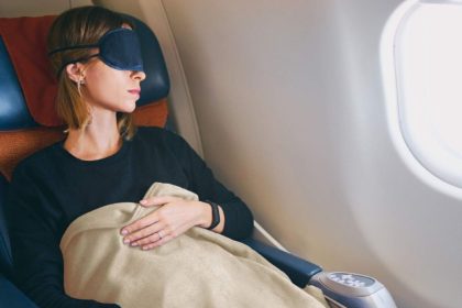 Using a blanket to sleep on the plane