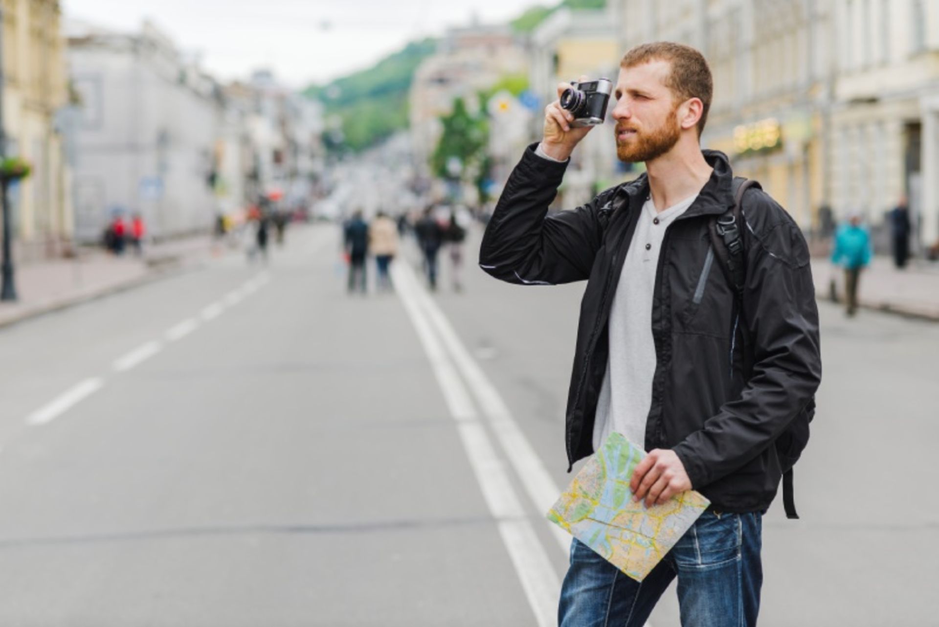A man on the street with a paper map