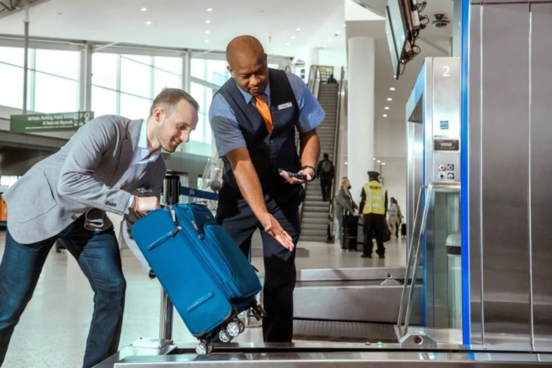 A man in the blue suitcase on the airport conveyor 