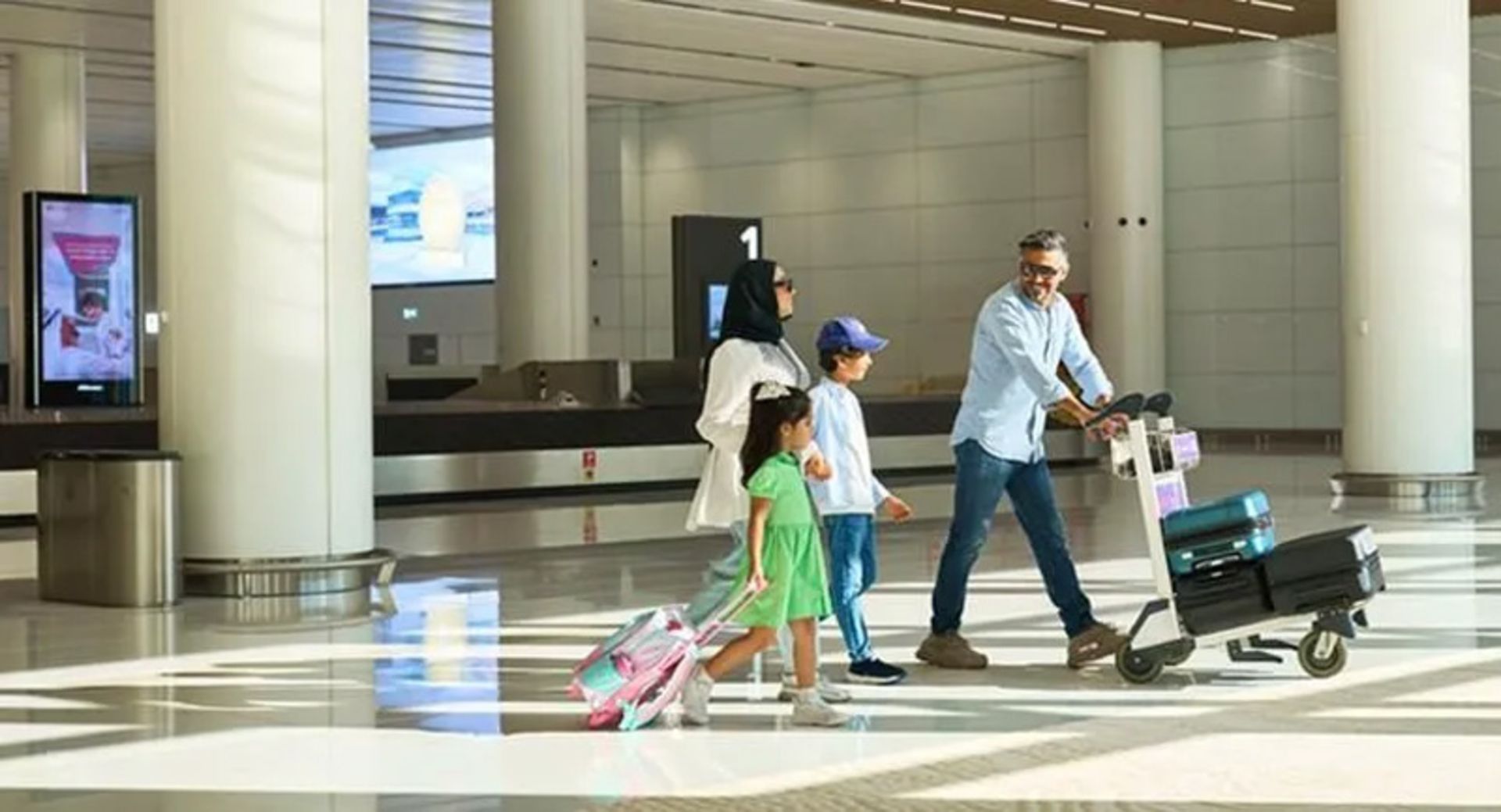 Family carrying luggage at Bahrain Airport