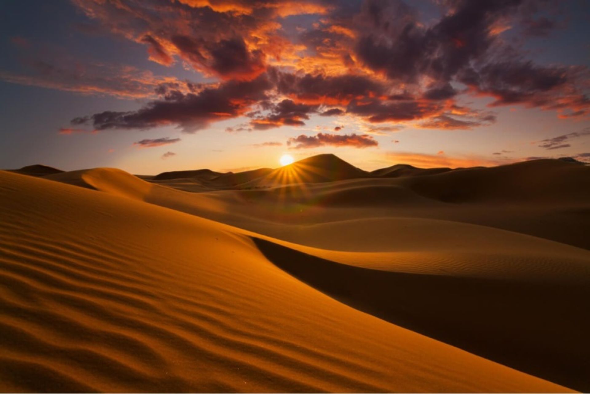 Smooth sand and clouds in the large Sahara of Africa Algeria