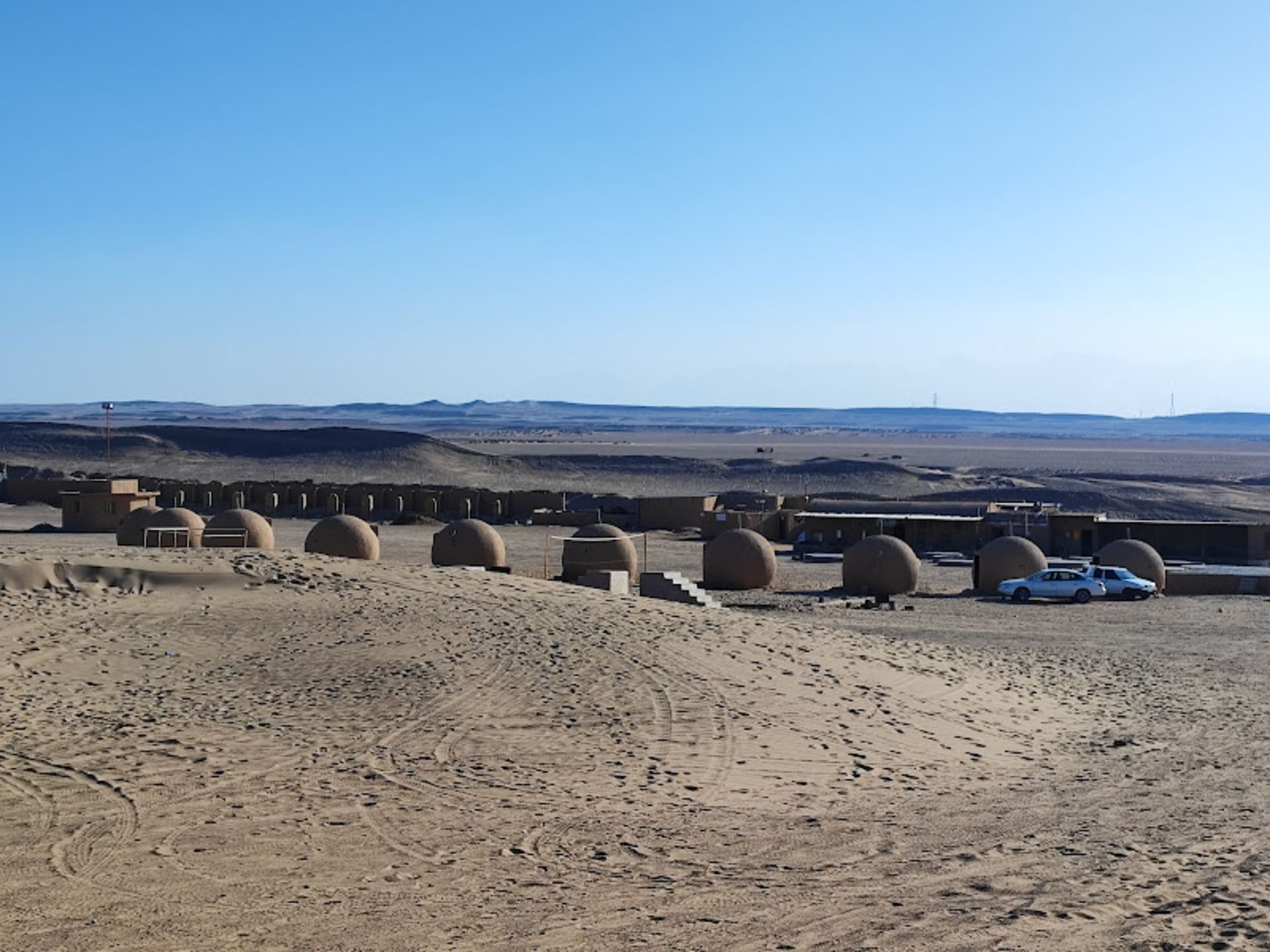 Hub house of straw mud in the rainy desert camp
