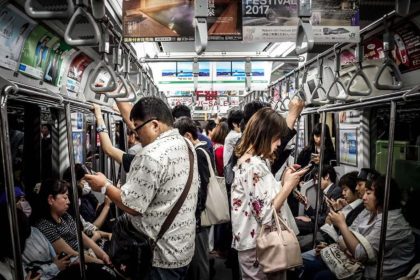 People are using the phone on the train in Japan