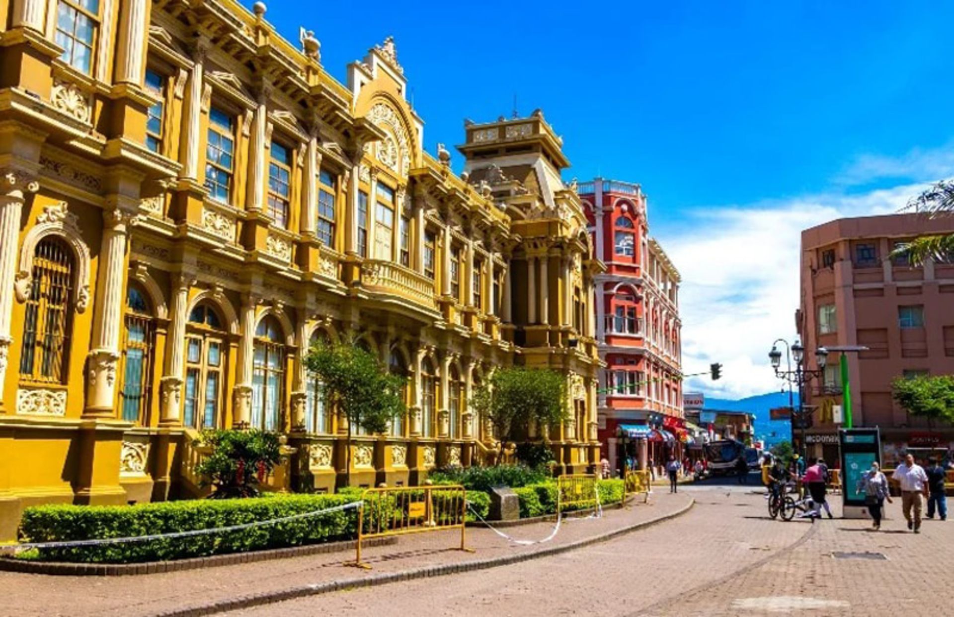 Street in San Jose Costa Rica with historic yellow and red buildings