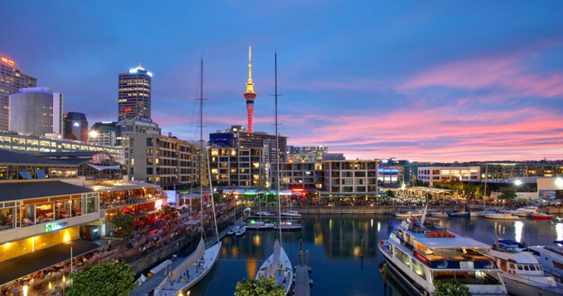 New Zealand Port Sunset with Sky Tower and boats in the dock