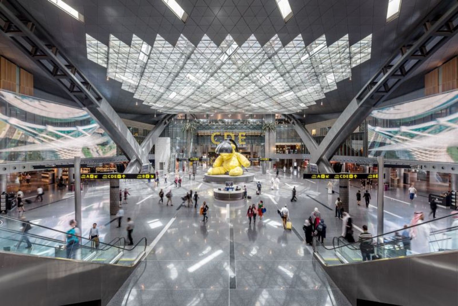 Golden bear and passengers at Hamad International Airport 