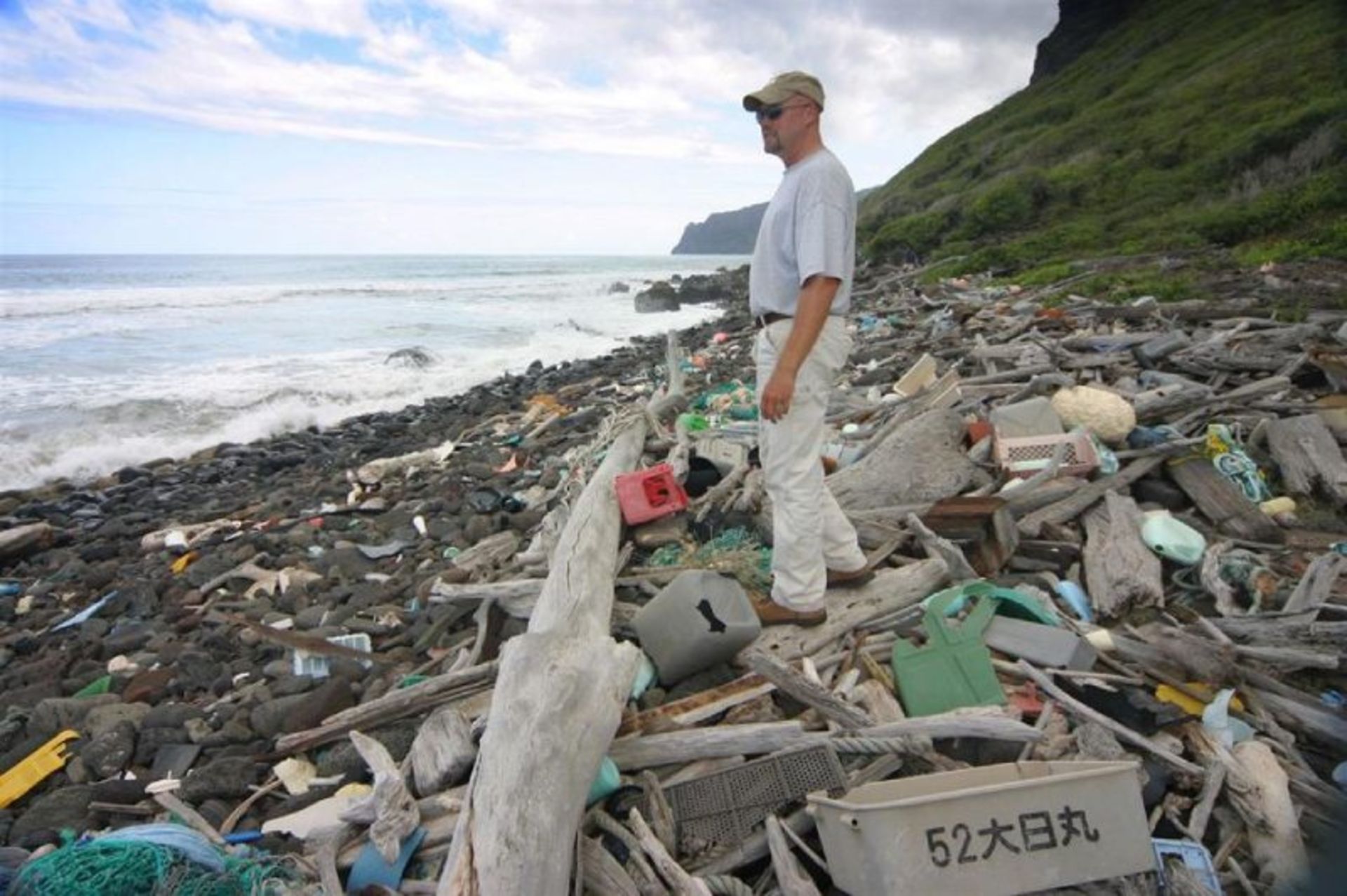 Man on the garbage on the Hawaiian coast
