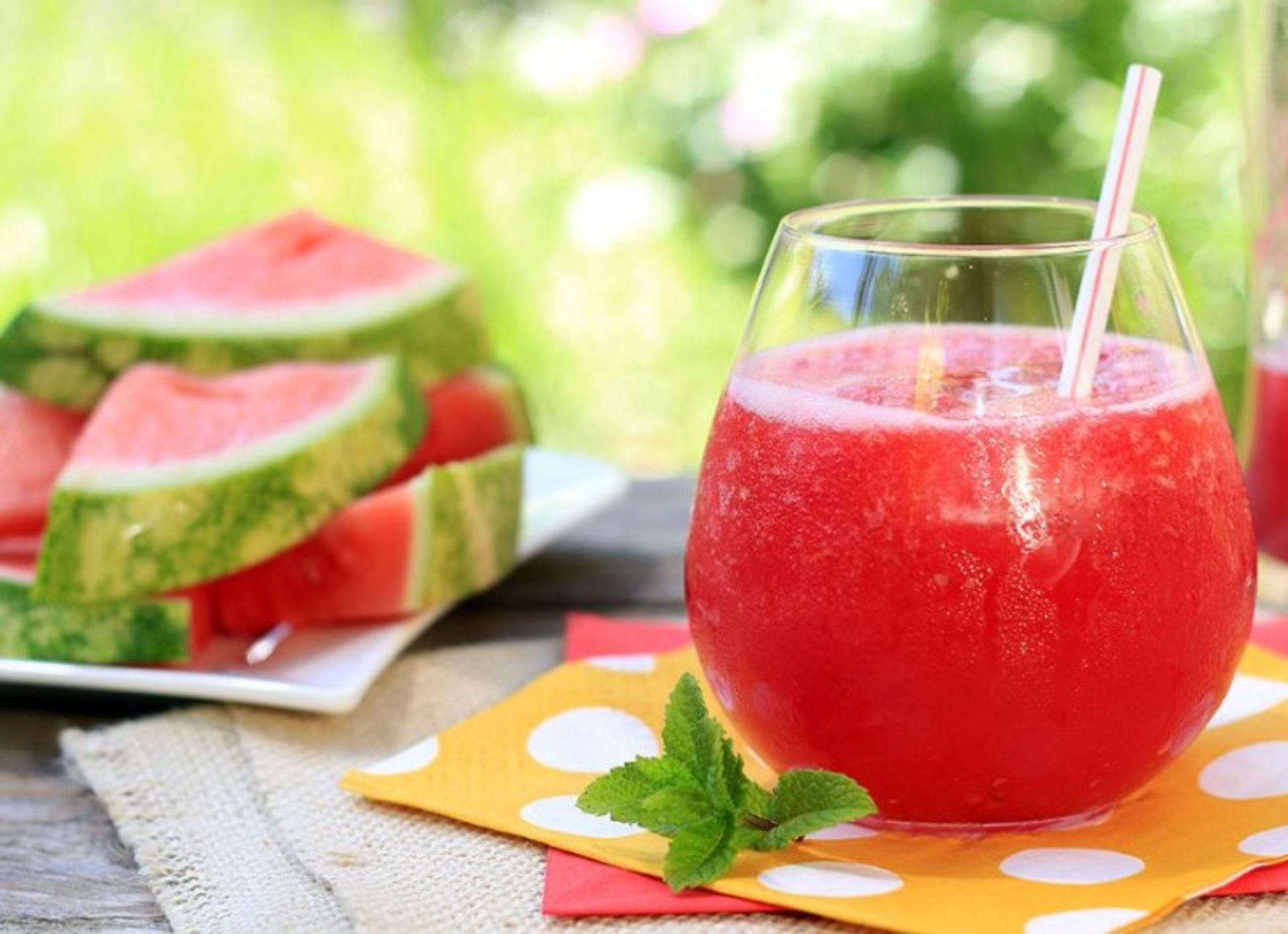 A glass of watermelon and honey with watermelon slices