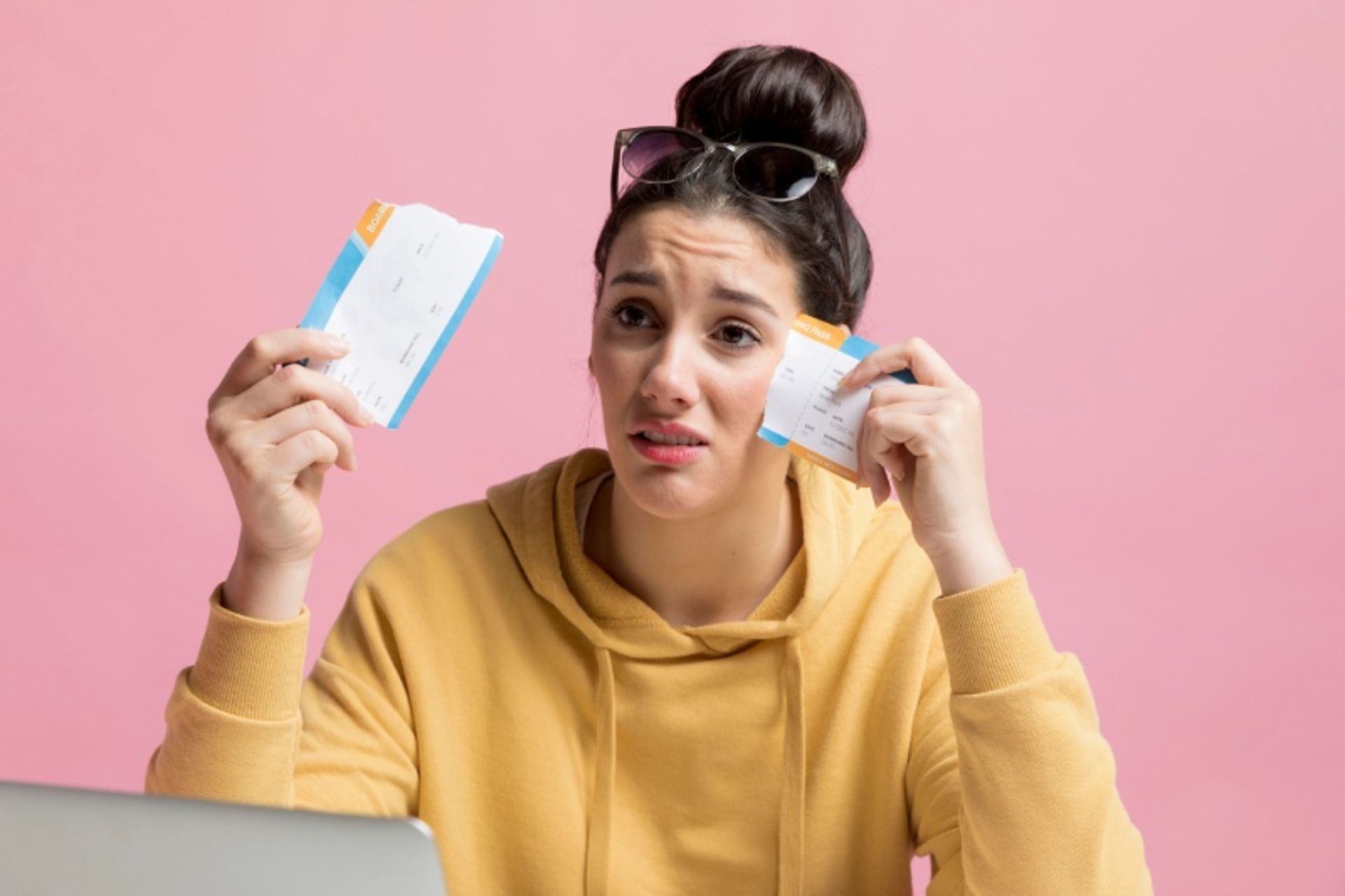 A sad woman with yellow dresses and tickets to travel
