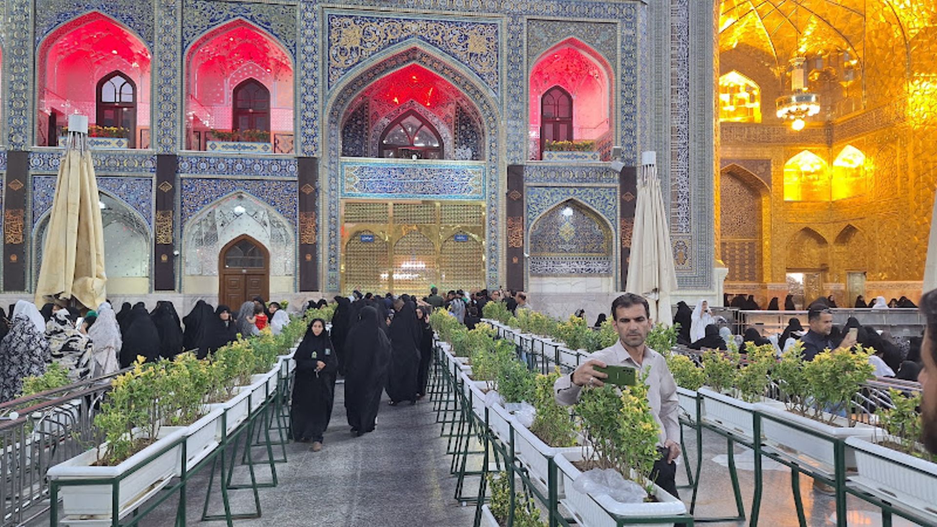 Pilgrims queue to enter the shrine of Reza (AS)