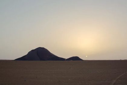 Monolite bin Amirah in the Great Sahara of Africa at sunset
