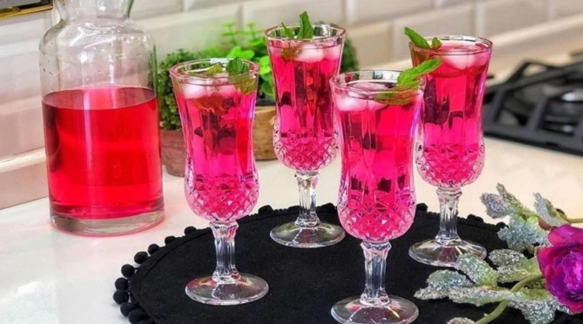 Pink Mohammadi flower syrup with ice and mint leaves