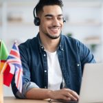 Young man learning foreign tongue with laptops