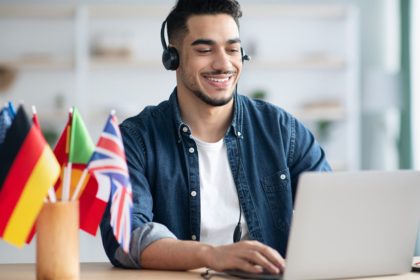 Young man learning foreign tongue with laptops