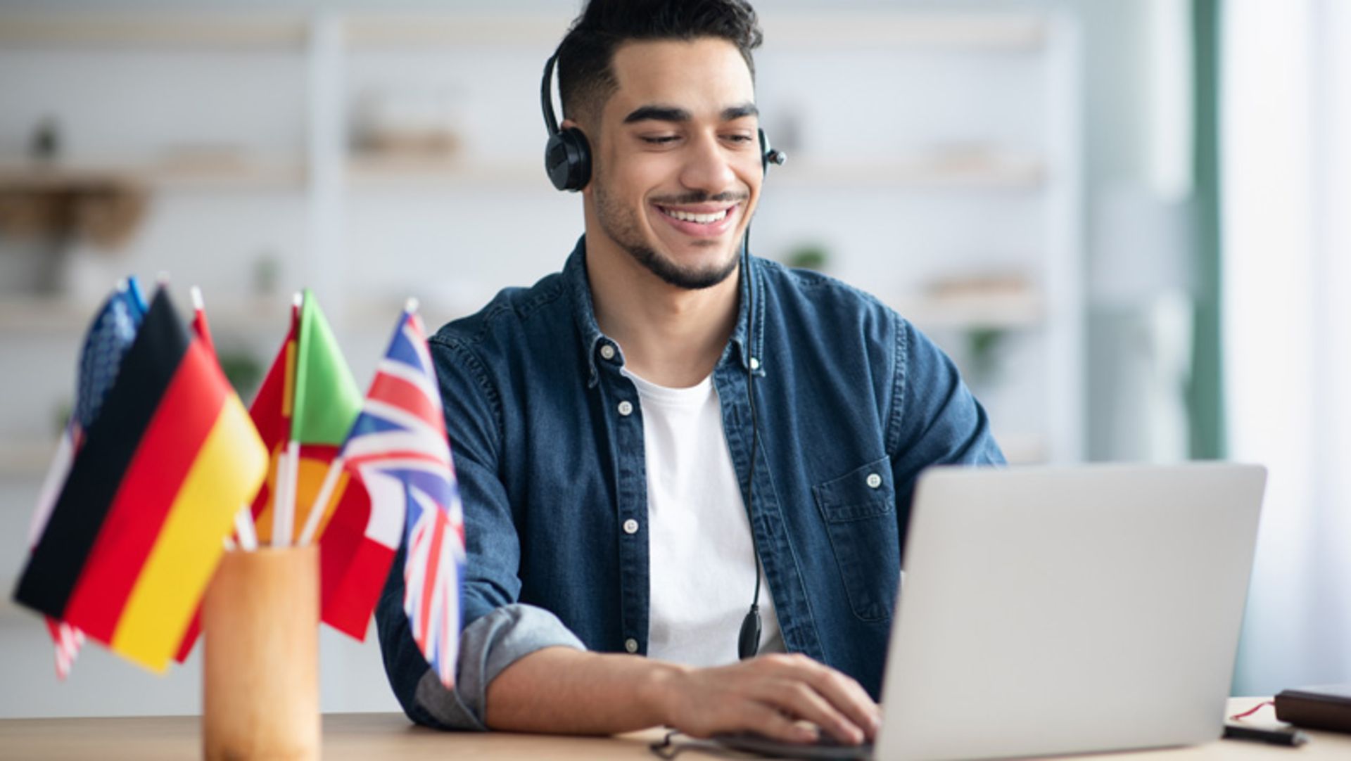 Young man learning foreign tongue with laptops
