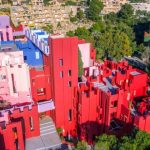 The pink building of the Red Wall of Spain and the surrounding nature