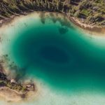 Aerial image of the emerald lake and the surrounding trees in the Yukan territory