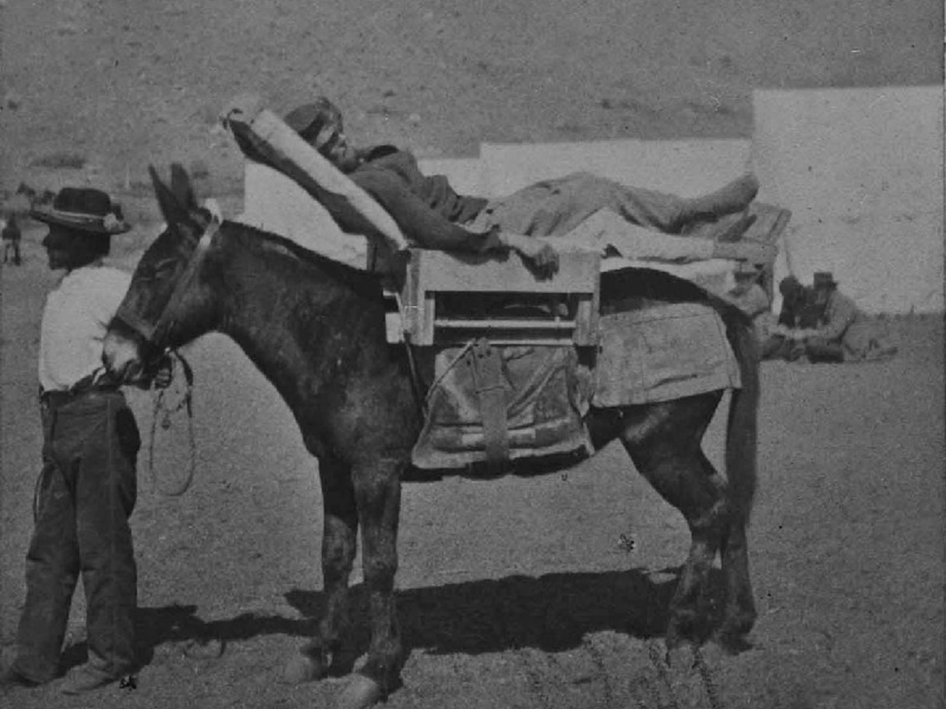 An old image of the injured person on the mule in the Moodok war