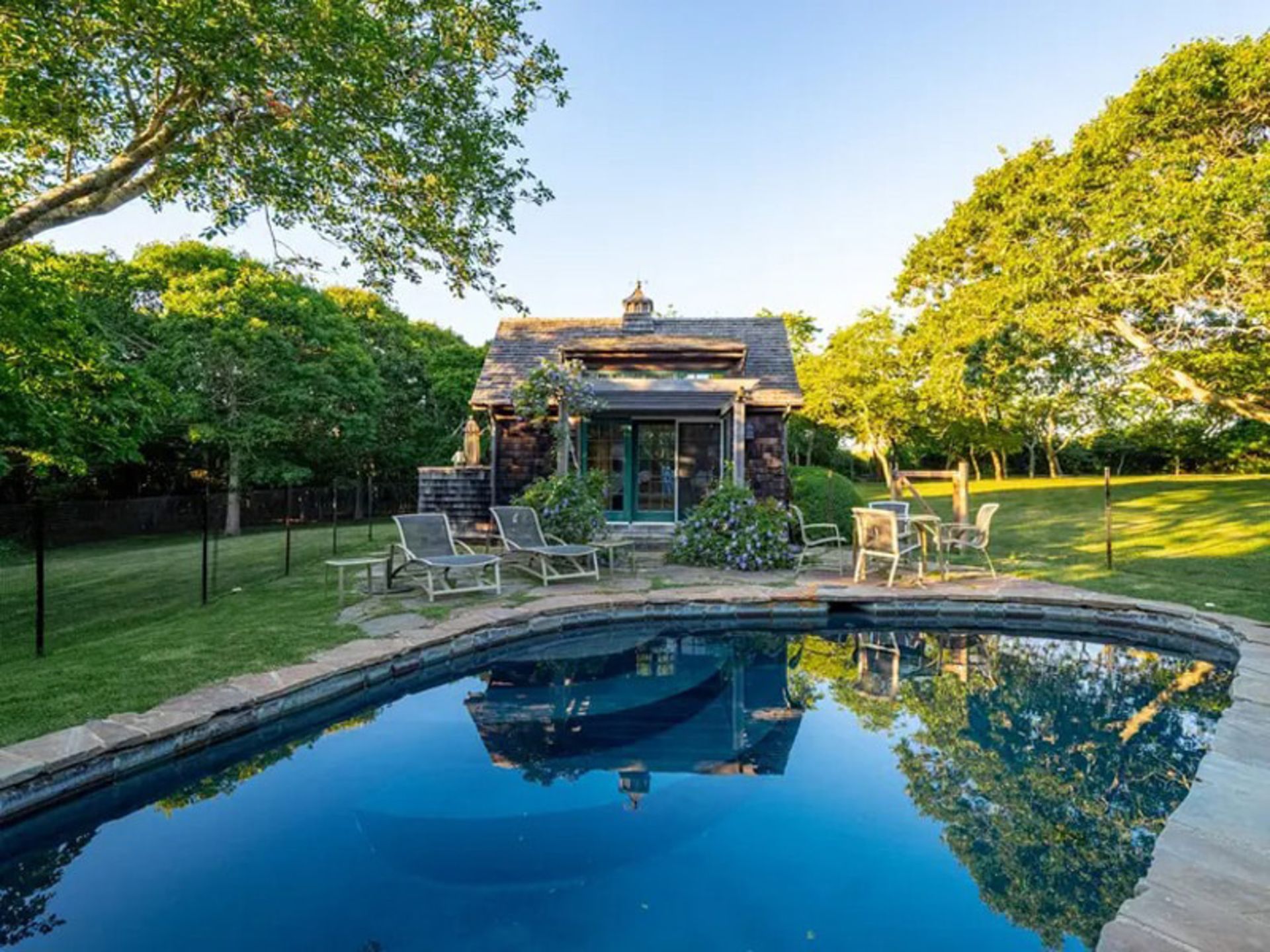 Montavak stone mansion pool in the middle of the lush yard