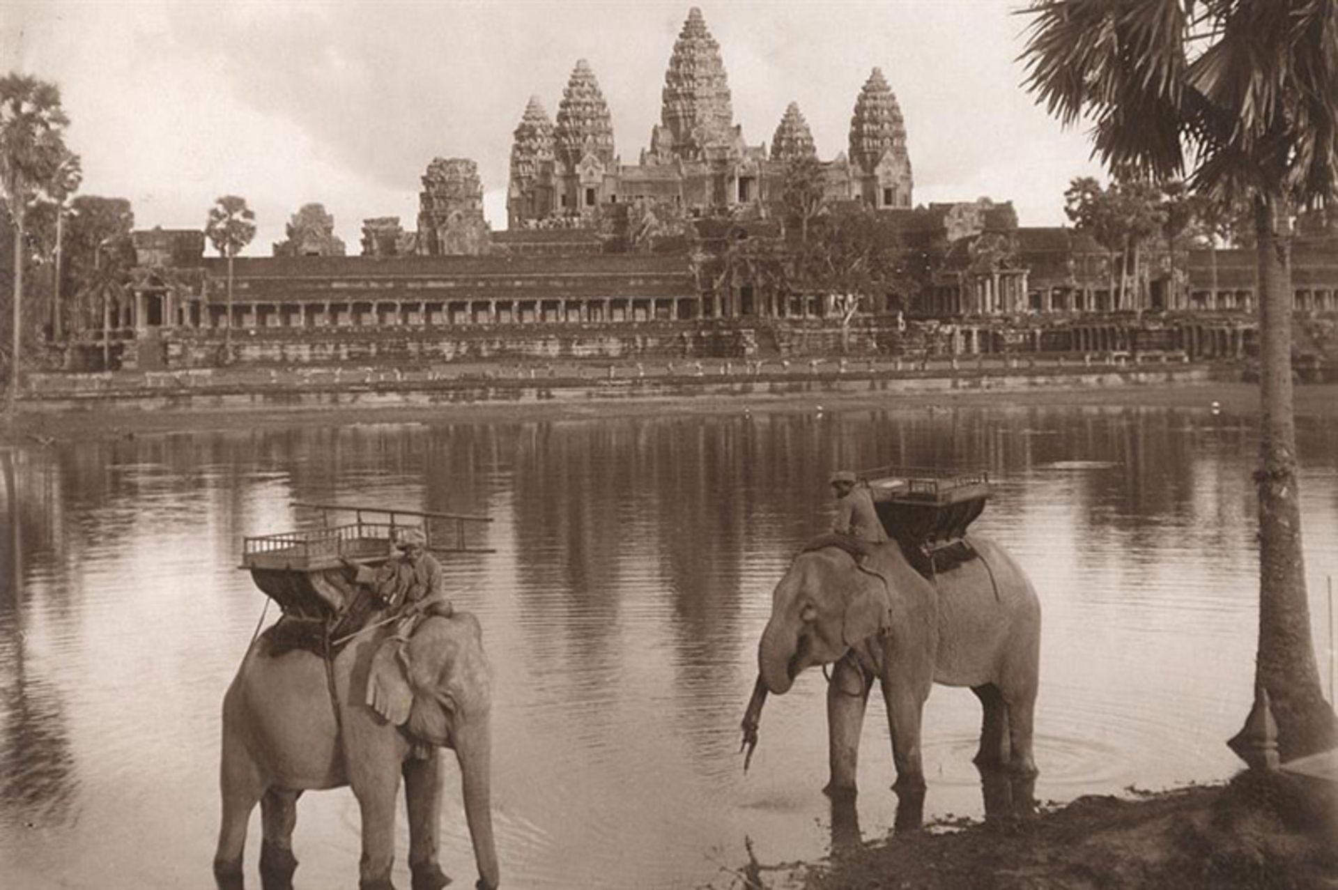 Old photo of two elephants by the lake and in front of Angkor Wat, Cambodia