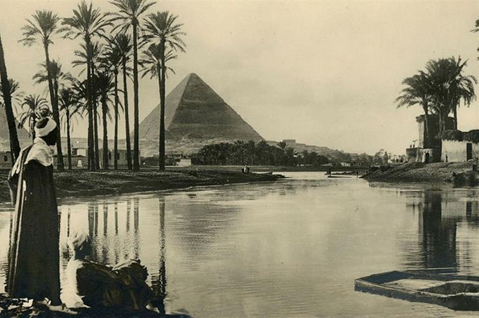 Old photo of two men opposite the Egyptian pyramids