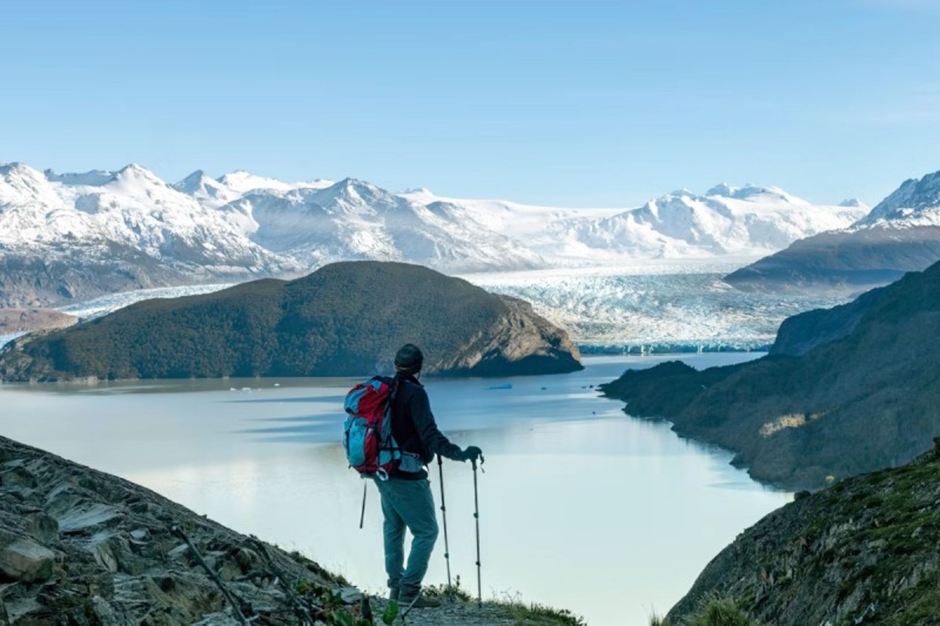 Climbing man at Torres Del Pine National Park watching snowy mountains