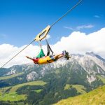 A person on the Zip Line Line Line Flat Fox XL over nature