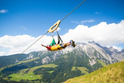 A person on the Zip Line Line Line Flat Fox XL over nature