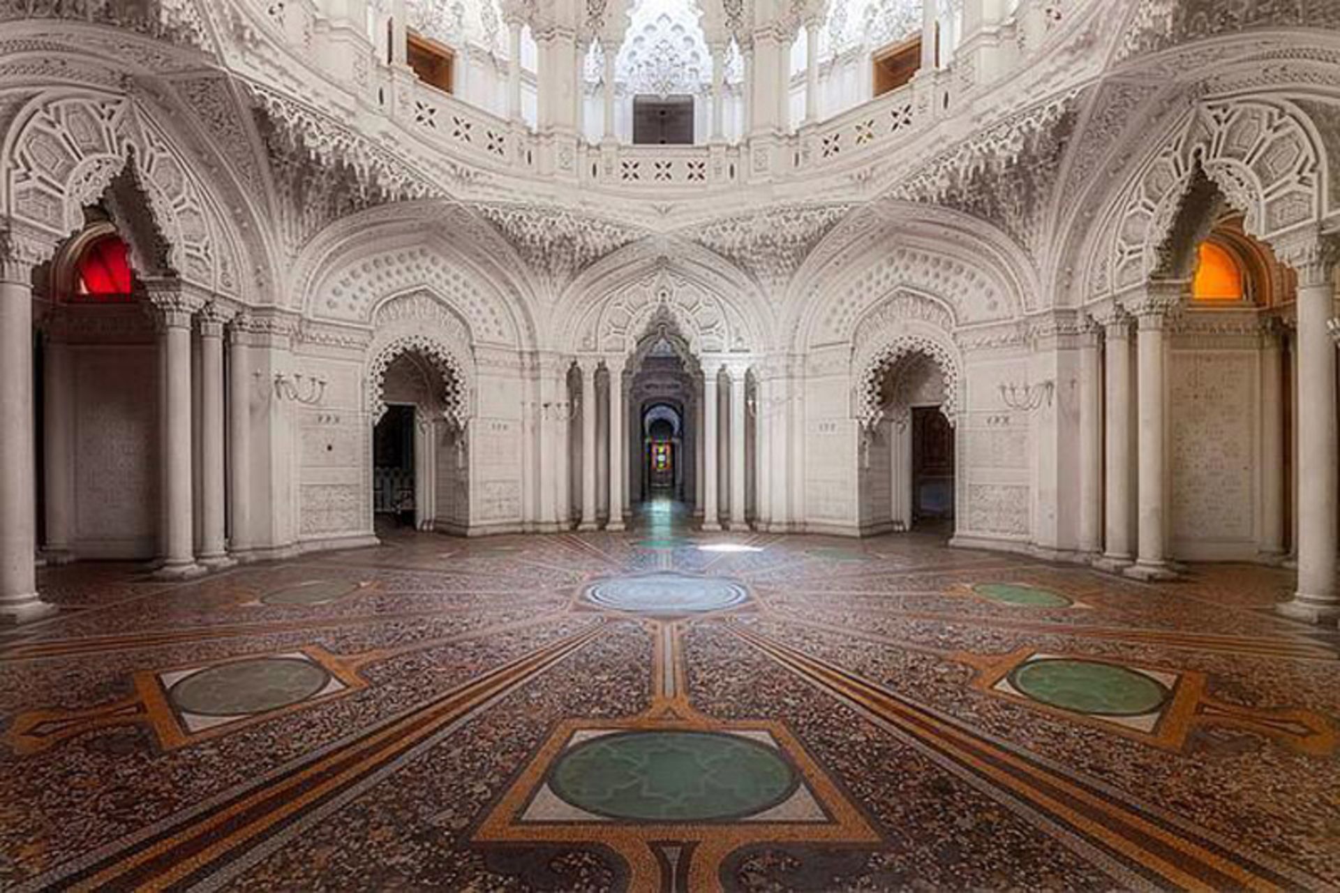 Large white white building with glass dome and tile floor