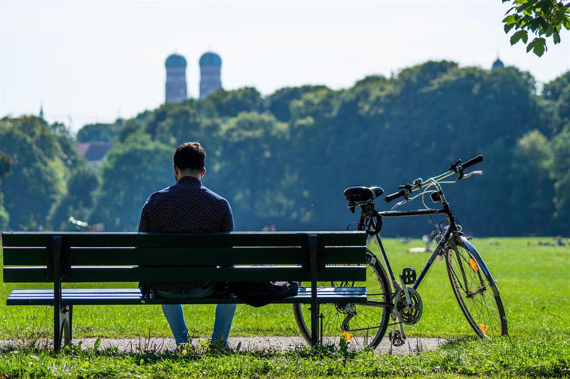 A bike man on a bench in Munich Park