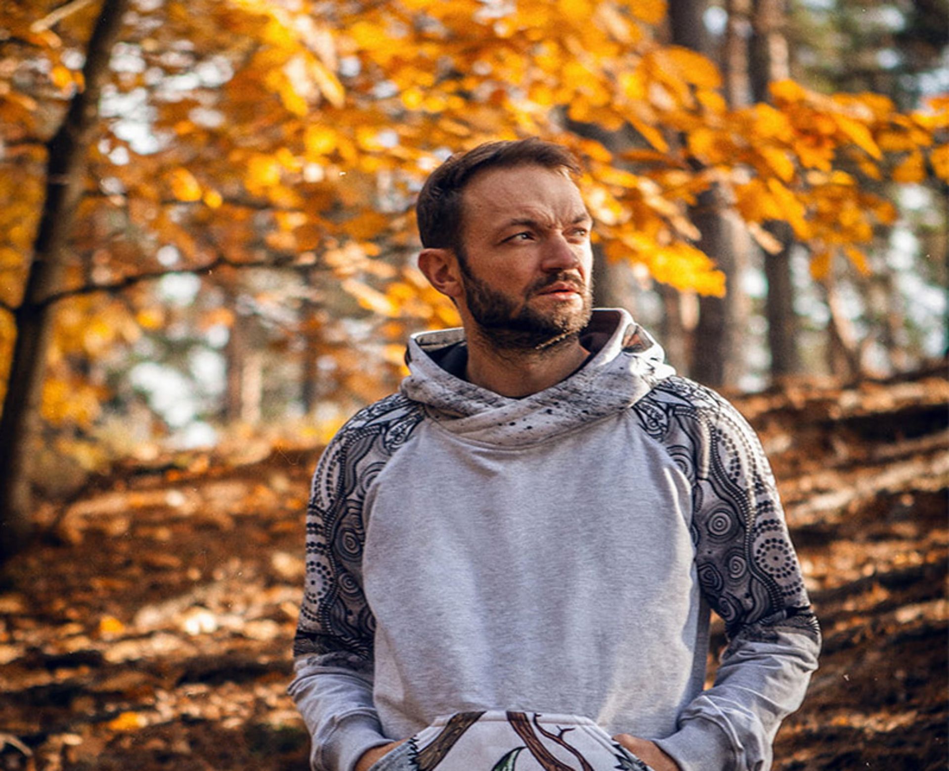A man with hoody clothing in the north autumn forest