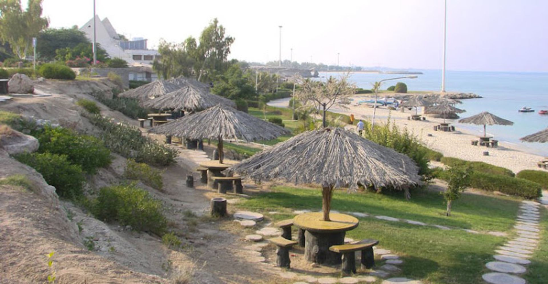 Kish Coral Beach with wooden tables and chairs