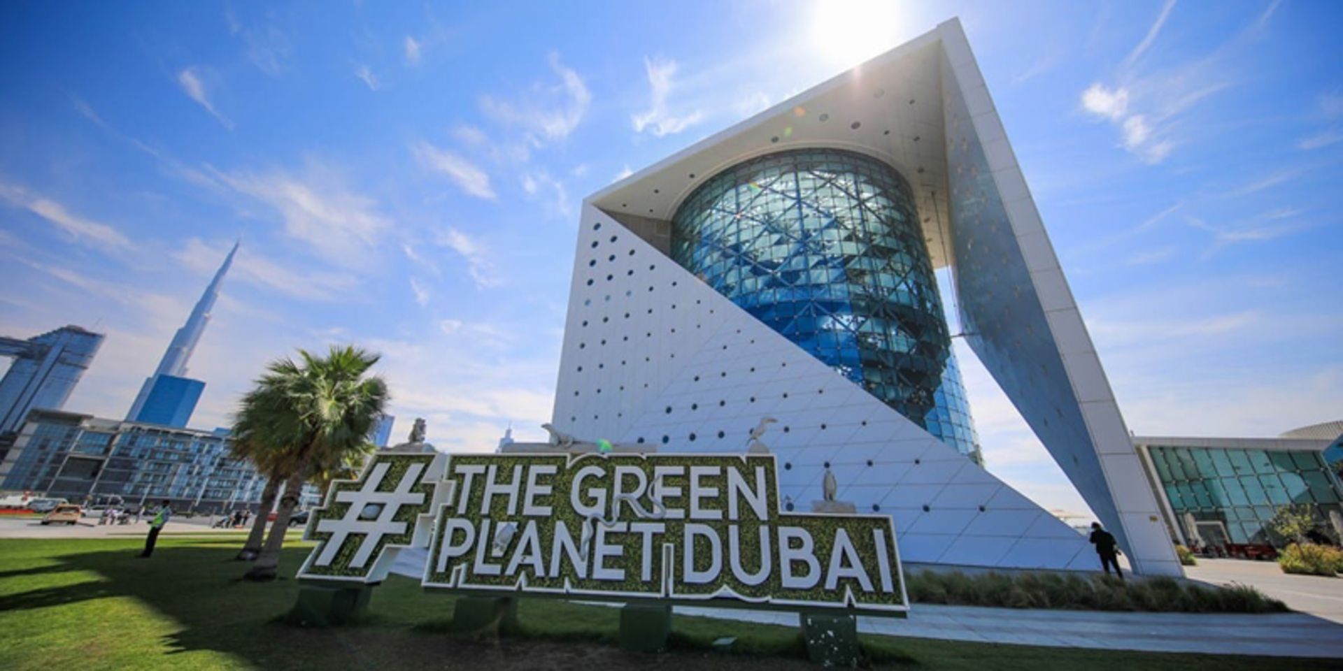 Cylindrical structure of Dubai's green planet under the blue sky