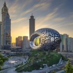 A view of Dubai at sunset with the future museum structure in the center