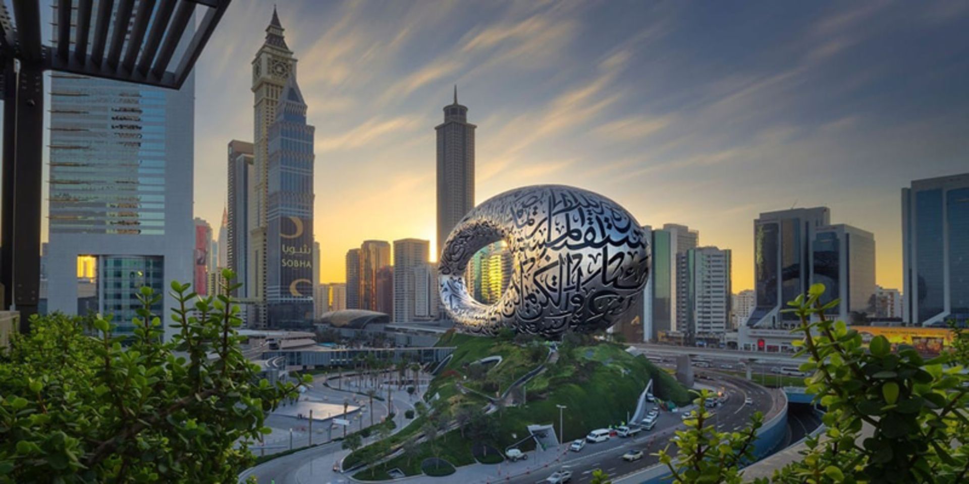 A view of Dubai at sunset with the future museum structure in the center