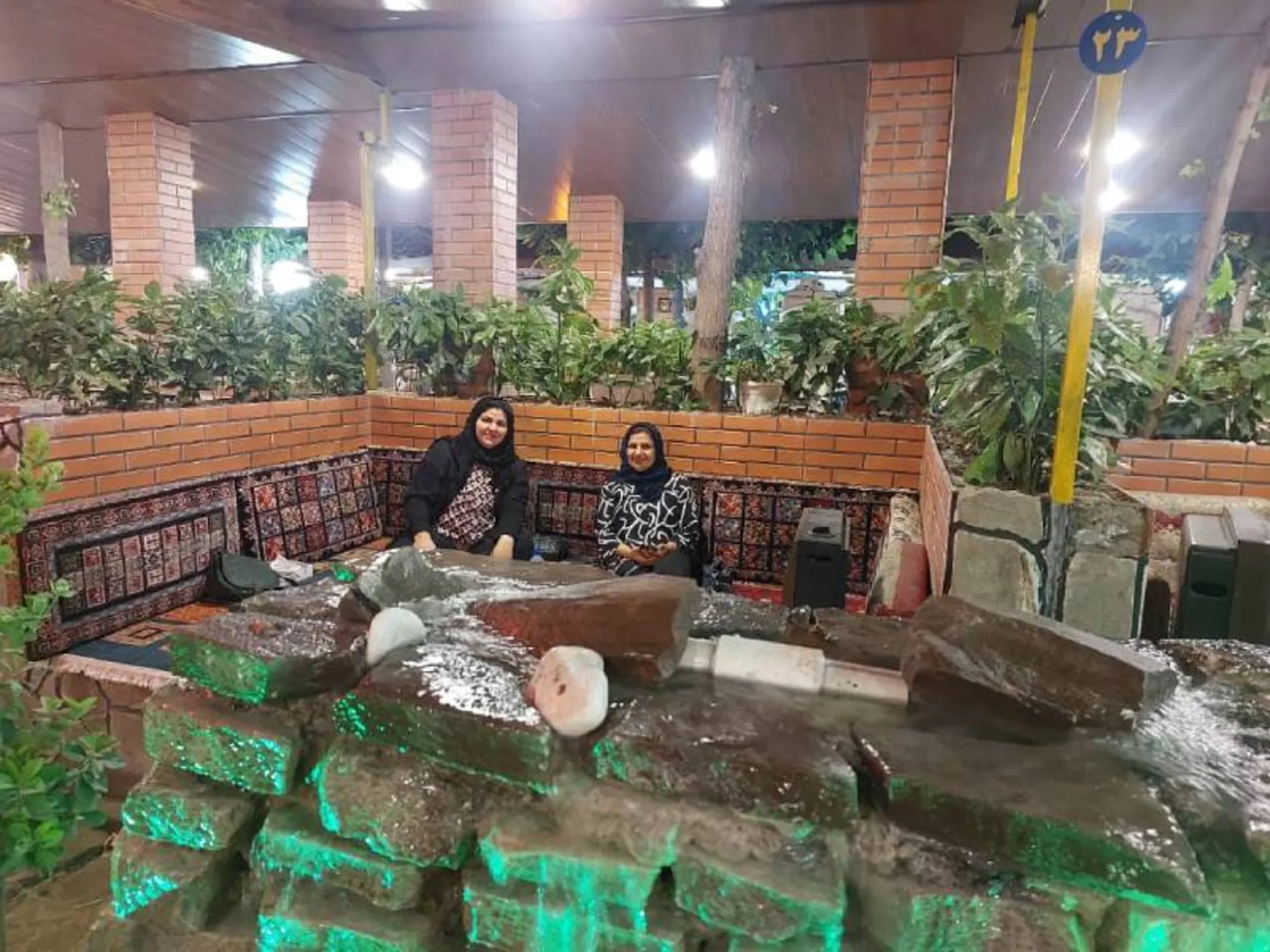 The beds and greenery of the traditional restaurant of Farahzad Farm