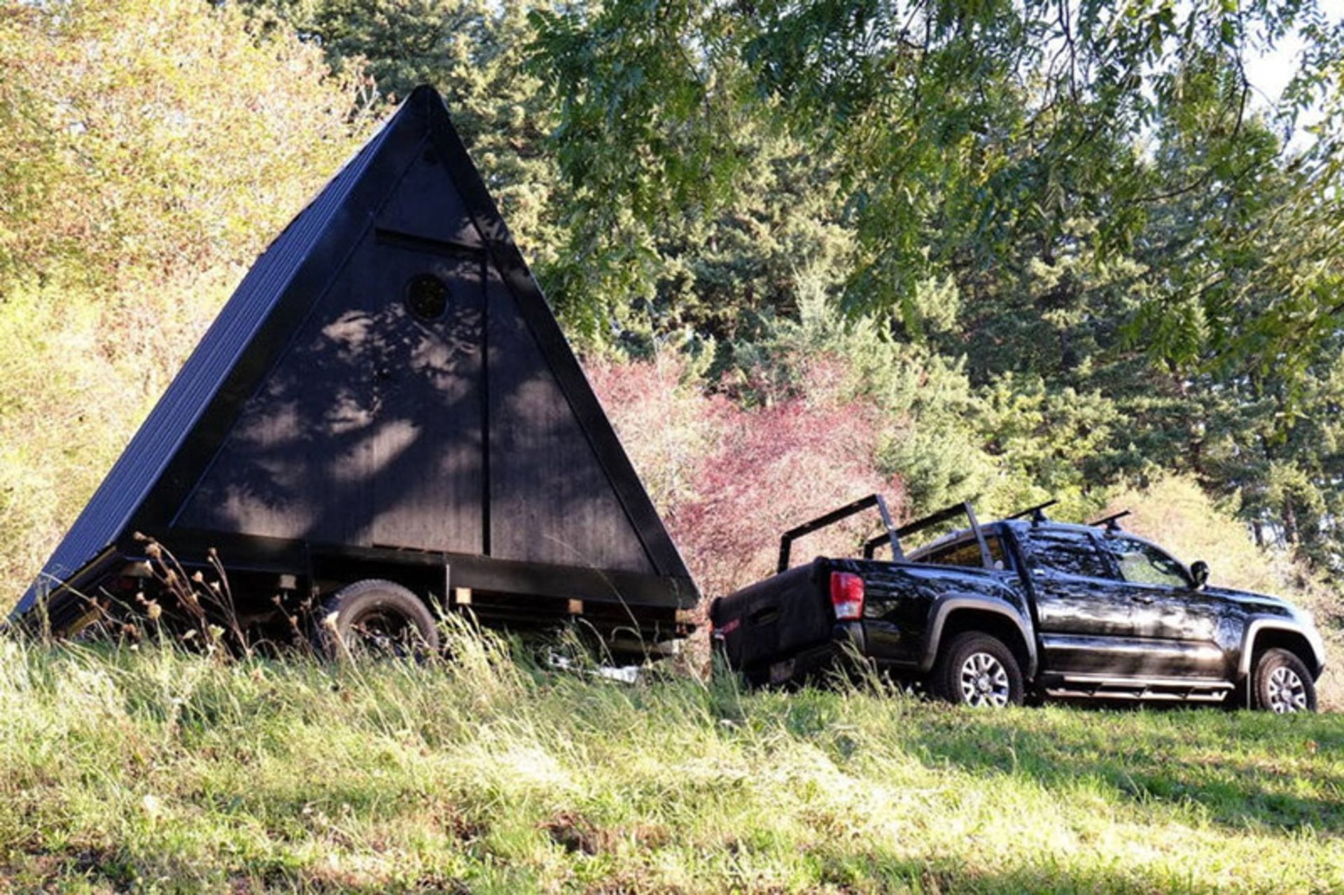 A car carrying a BV hut in nature