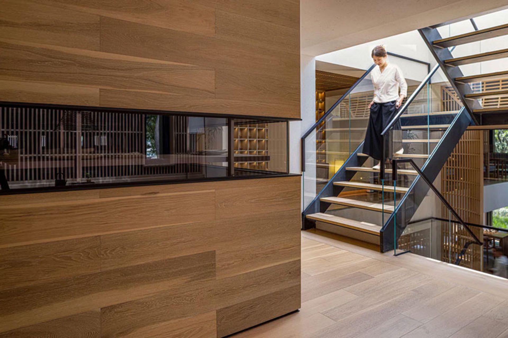 The wooden-metal staircase of the Blue Lake Tea House next to the grooved wooden wall